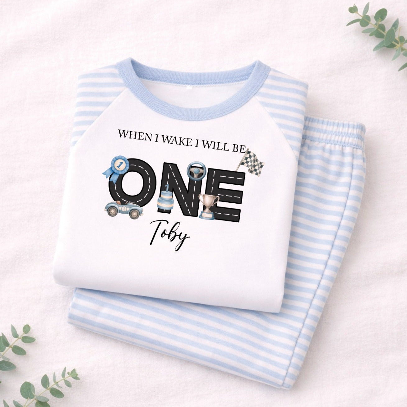 Children's white shirt with blue striped sleeves and text on a light pink background