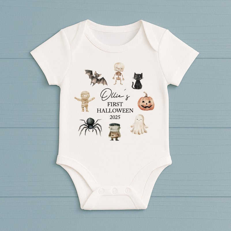 Baby onesie with Halloween-themed graphics and text on a blue background
