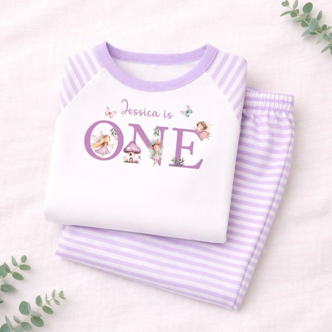 Children's pajama set with 'Jessica is ONE' text on a light background