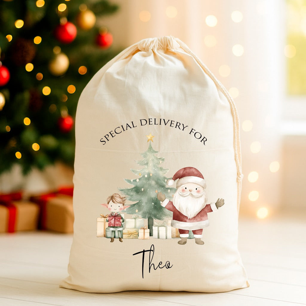 Personalized Christmas gift bag with Santa and tree design in front of a decorated Christmas tree.
